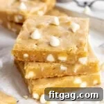 Stacked blondie bars with white chocolate chips.