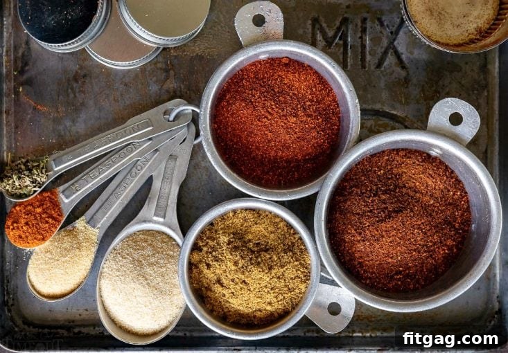 Taco seasoning ingredients laid out in measuring spoons and cups before mixing.