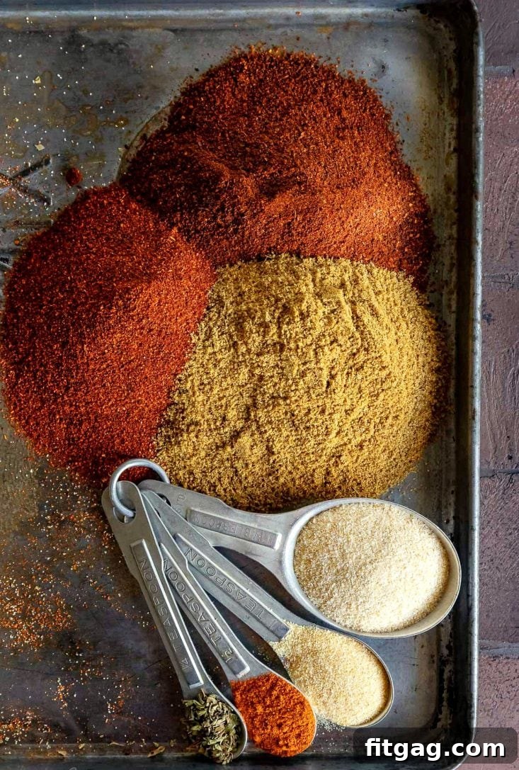 Homemade taco seasoning spread on a baking sheet, showcasing its vibrant colors.