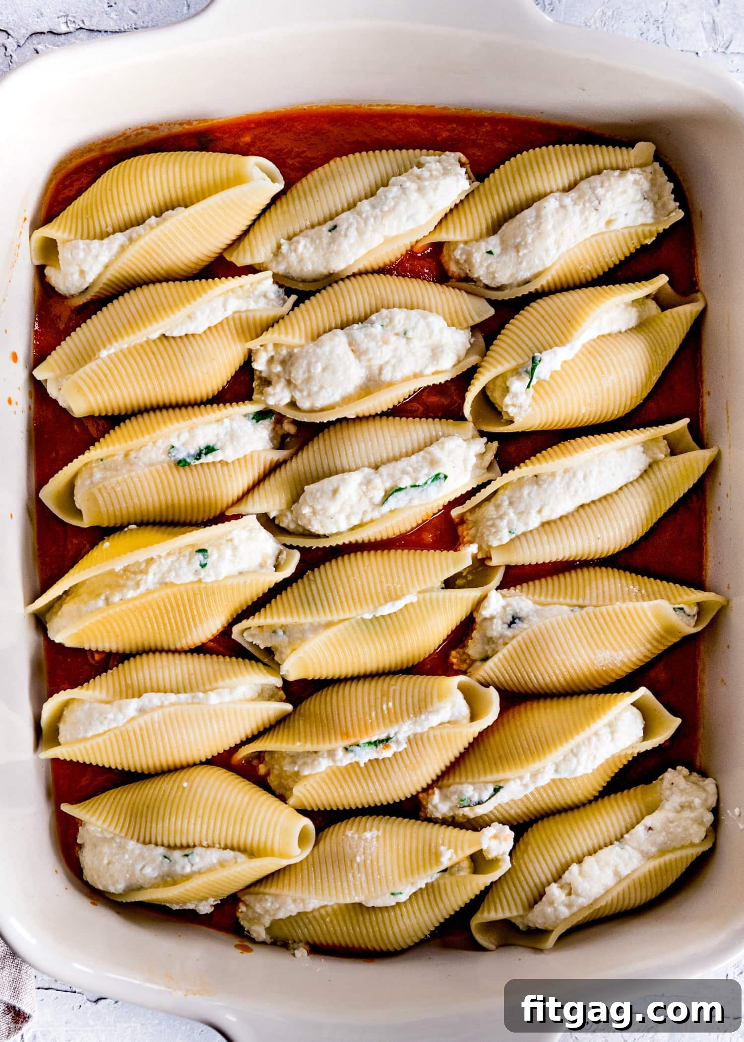 Stuffed Shells Ready for Baking Stuffed shells recipe showing uncooked shells filled with cheese mixture.