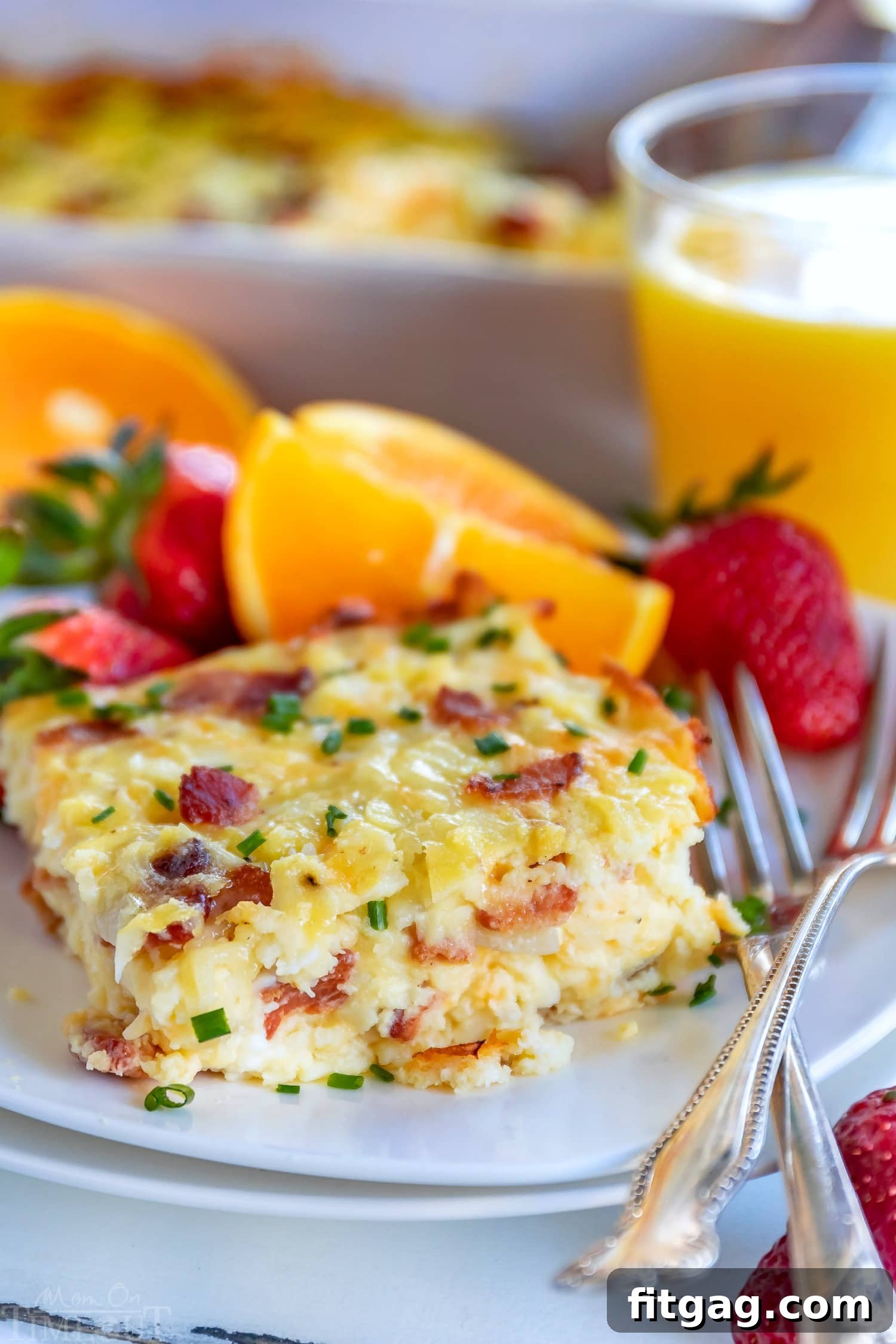 Loaded Hash Brown Breakfast Bake 5 A slice of Hash Brown Breakfast Casserole on a plate, garnished with fresh chives
