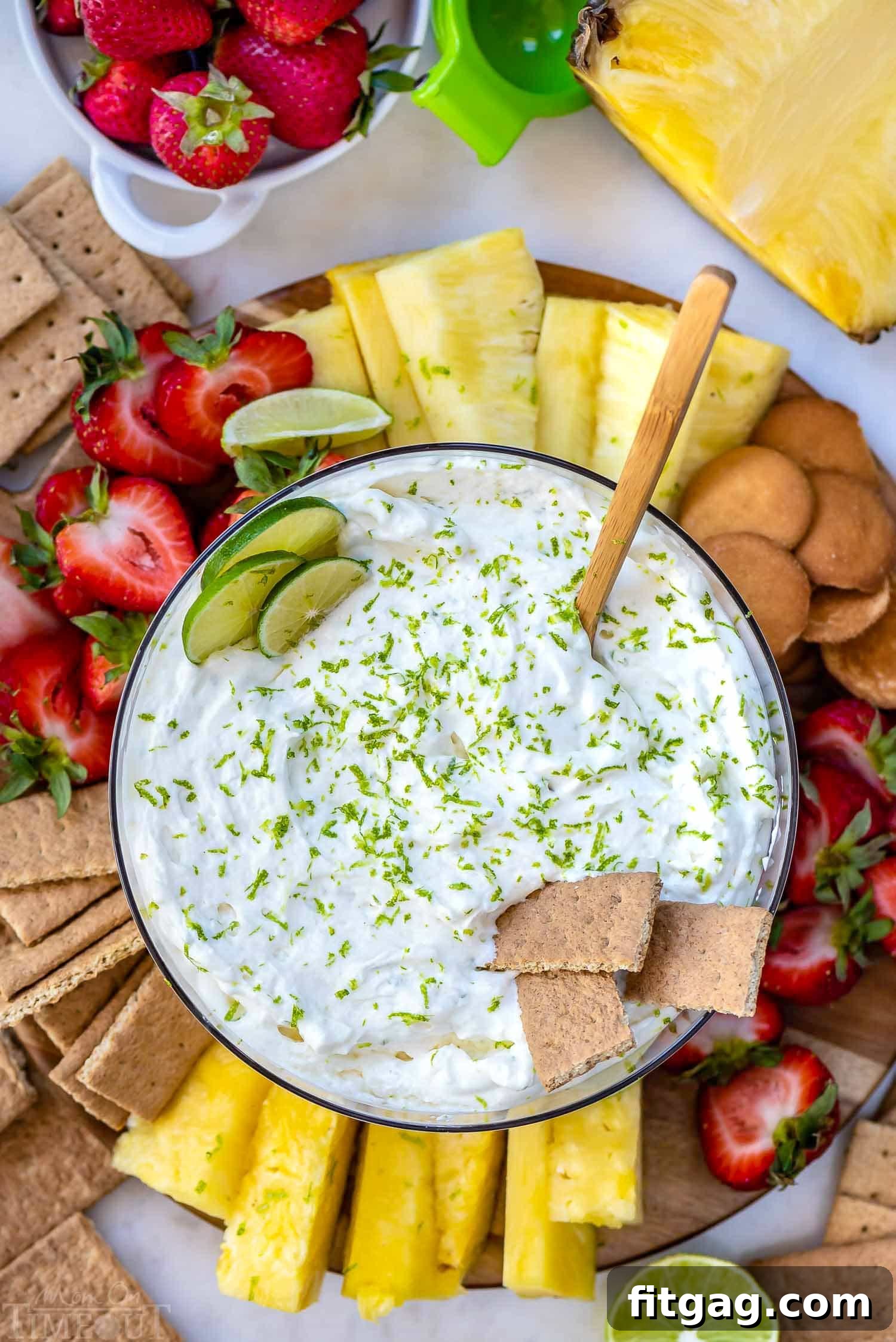 Zesty Key Lime Fruit Dip 6 Top-down view of Key Lime Pie Fruit Dip served with strawberries, pineapple, and graham crackers