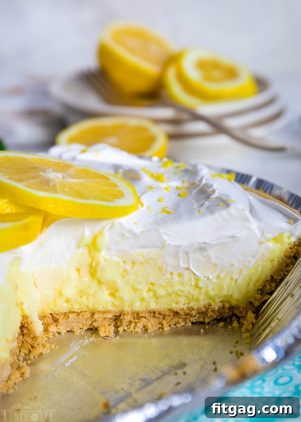 A whole No-Bake Lemon Pie in a pie tin with one slice removed