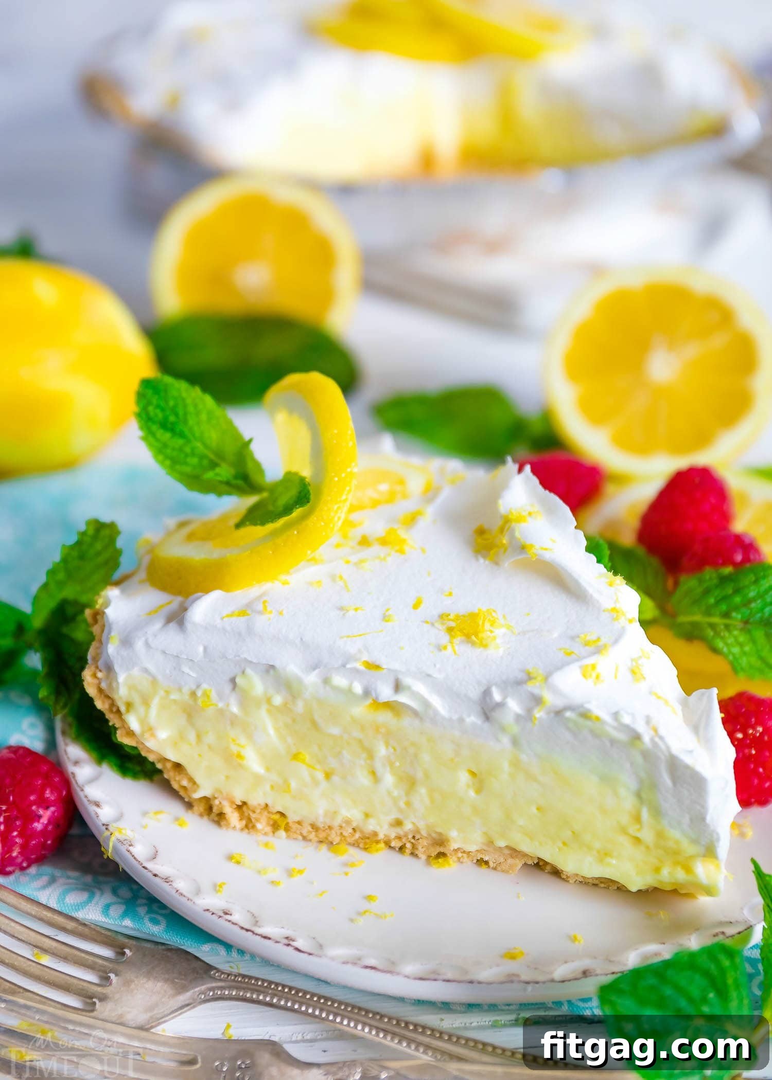 Zesty No-Bake Lemon Delight 7 No Bake Lemon Pie with a generous whipped cream topping on a white plate, ready to be served.