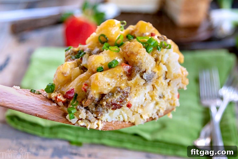 A serving of Slow Cooker Tater Tot Breakfast Casserole being scooped directly from the slow cooker, showing the layers of eggs, cheese, and tots.