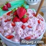Strawberry Fluff in bowl topped with fresh strawberries
