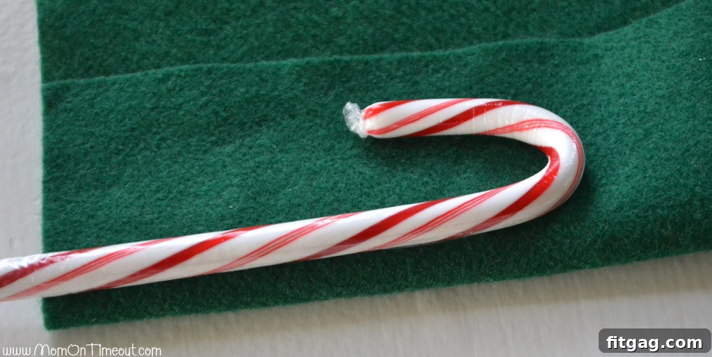 Measuring felt for candy cane Christmas tree craft