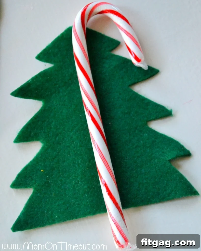 Cutting green felt into a Christmas tree shape