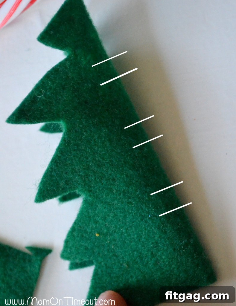 Cutting slits in felt tree for candy cane insertion