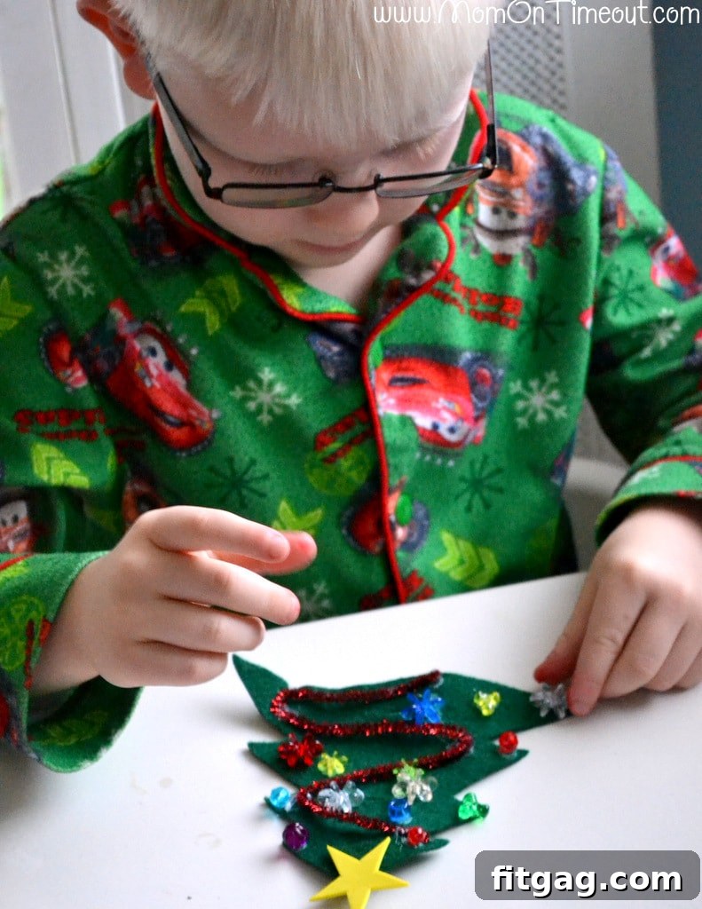 Decorating the felt Christmas tree with a star and ornaments