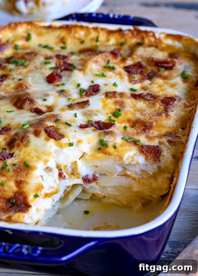 Homemade scalloped potatoes with crispy bacon bits, melted cheese, and tender potato layers, ready to be baked.