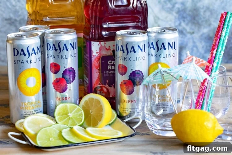 Festive Mocktail Station Idea A festive mocktail station with various sparkling water bottles, juices, ice, and sliced fruit, perfect for entertaining