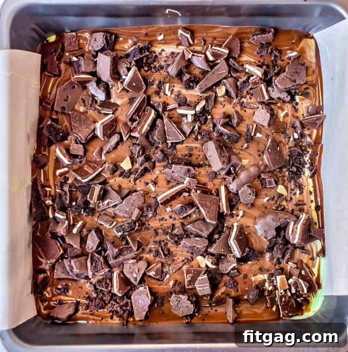 Pieces of Mint Chocolate Bark topped with crushed cookies