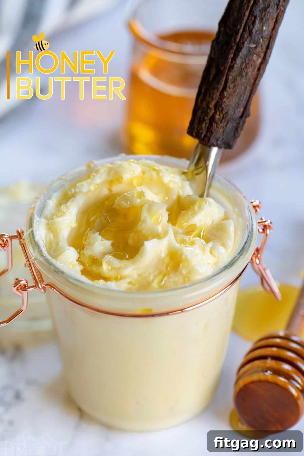 The BEST Honey Butter is ridiculously easy to make and tastes amazing! With just 4 ingredients, this homemade honey butter recipe is perfectly sweet and creamy and is incredible smeared on cornbread, biscuits and homemade dinner rolls! // Mom On Timeout #honeybutter #honeybutterrecipe #homemade #condiments #butter #honey Easy homemade honey butter recipe in a charming glass jar with golden honey drizzled over the top, showcasing its creamy texture.