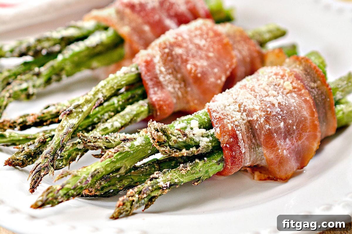 Close-up of bacon wrapped asparagus plated on a white dish
