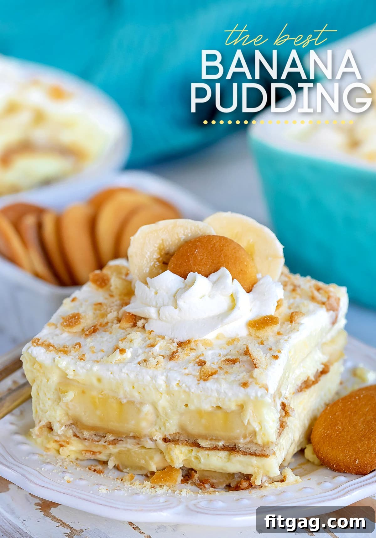 The best banana pudding recipe served on a white plate garnished with whipped cream and Nilla wafers.