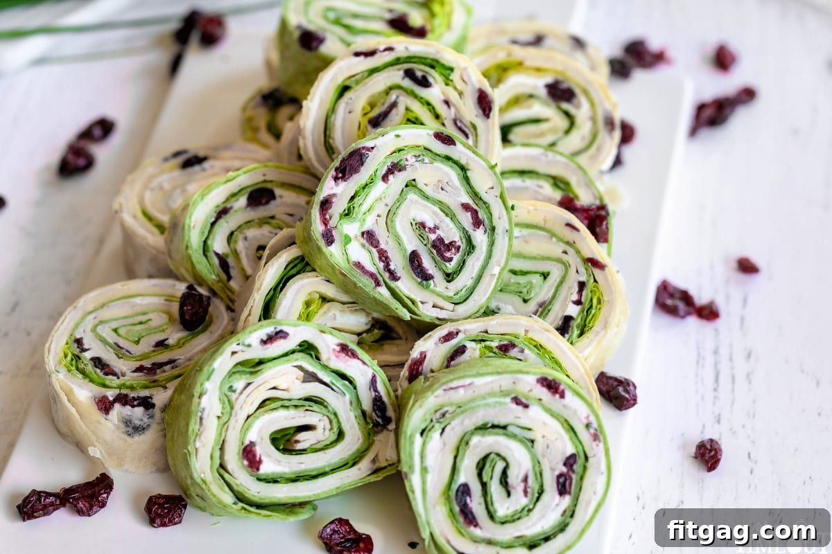 turkey pinwheels stacked high on a white cutting board