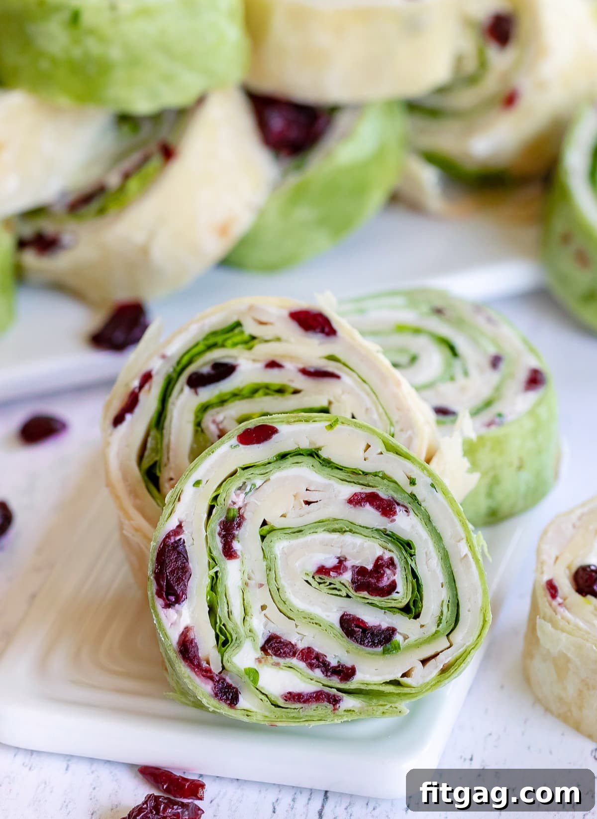 turkey pinwheels recipe with dried cranberries on small white board