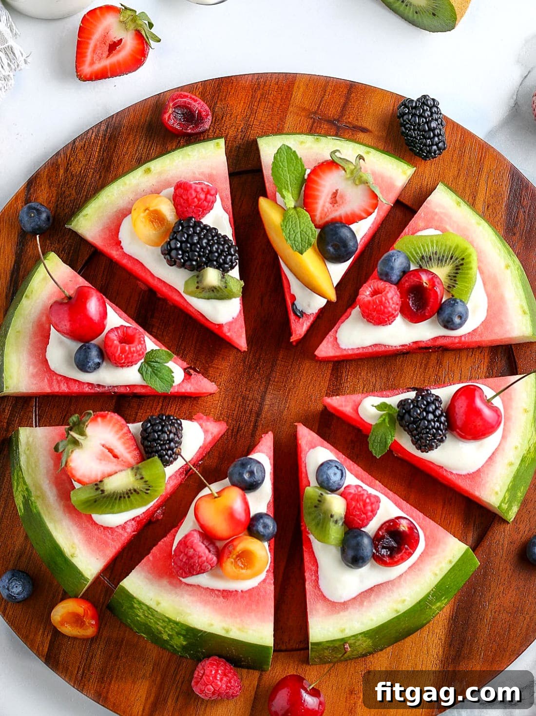 Summer's Sweetest Slice 4 A large, vibrant watermelon pizza, complete with a creamy glaze and an abundance of fresh, colorful fruit toppings, meticulously cut into individual slices and displayed on a wooden serving board.