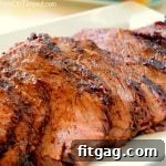 Seared Tri-Tip with Savory Three-Onion Glaze 5 Close-up of a perfectly grilled and sliced beef tri-tip roast, ready to be served.