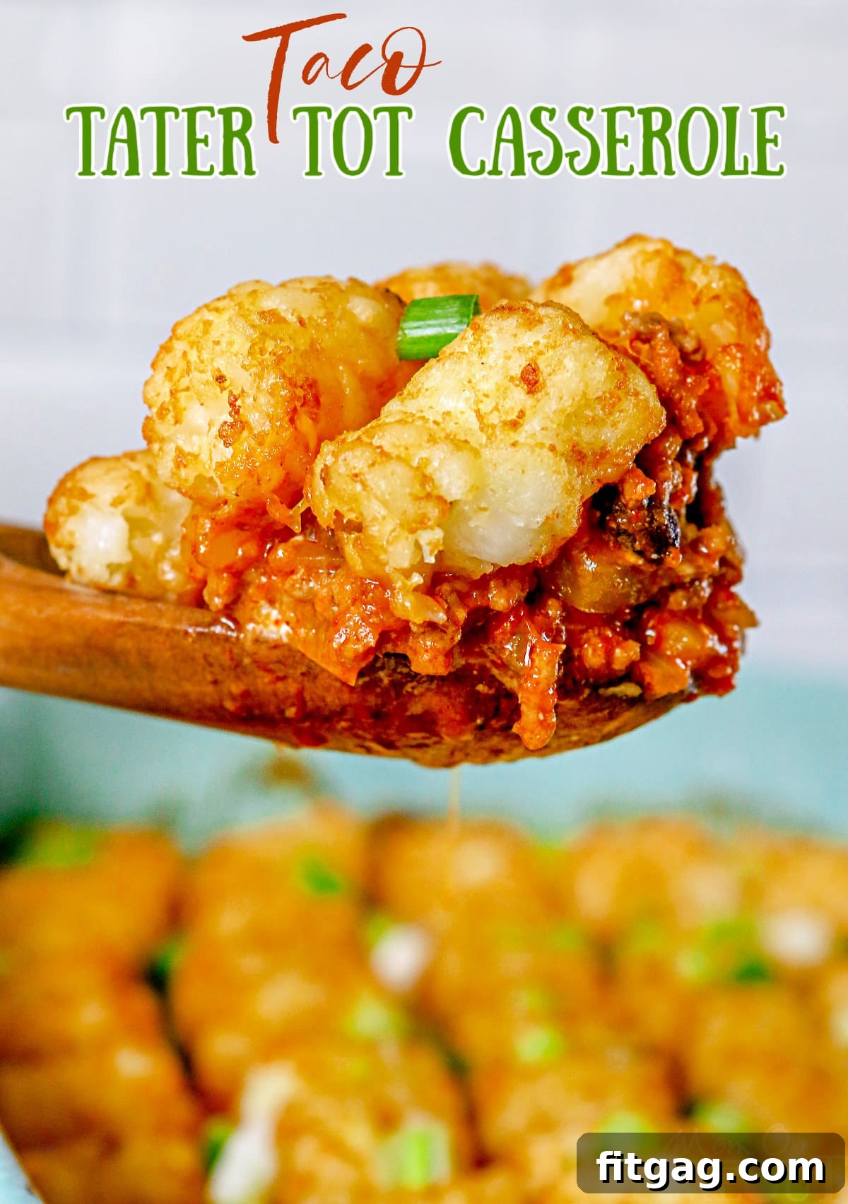 Fiesta Tater Tot Bake 2 Taco Tater Tot Casserole being scooped out of a baking dish, highlighting its delicious layers with a wooden spoon. Text overlay provides recipe context.