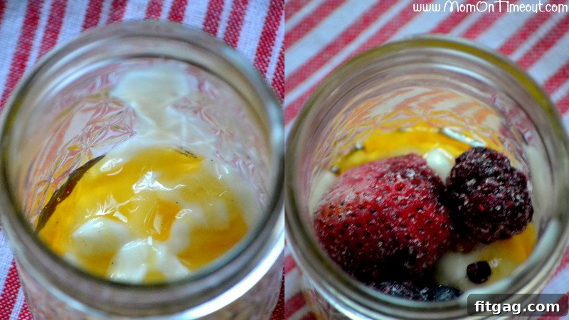 Hands layering honey, yogurt, and berries into a glass jar for a make-ahead parfait