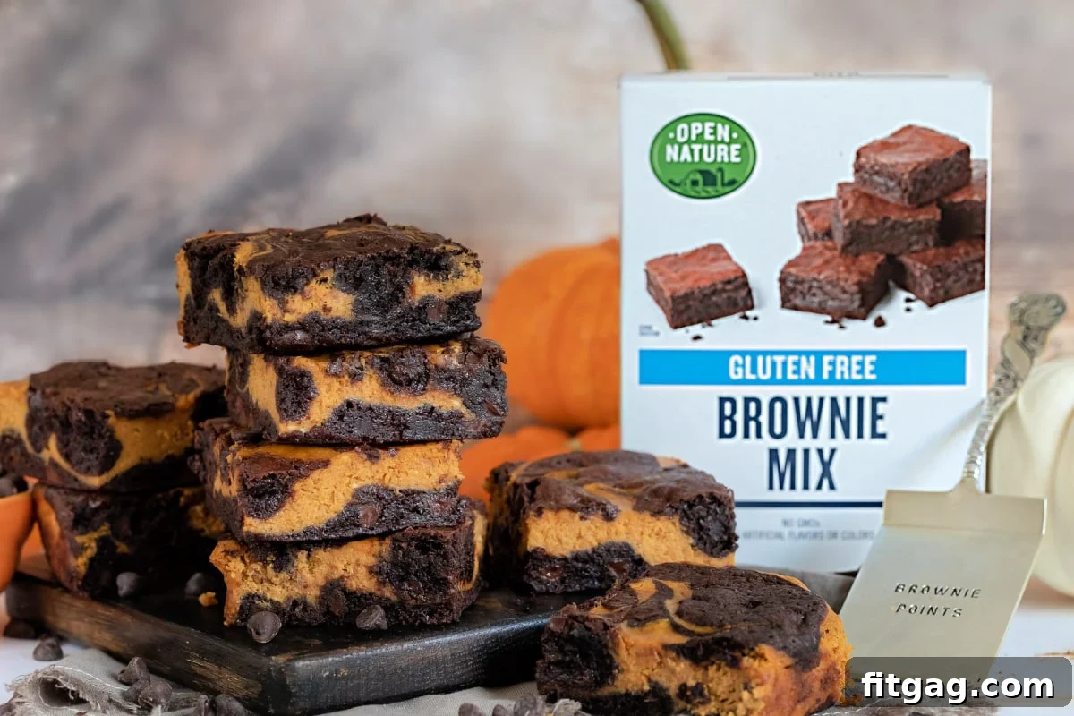 Pumpkin brownies on a wood board with a brownie mix box on the side.
