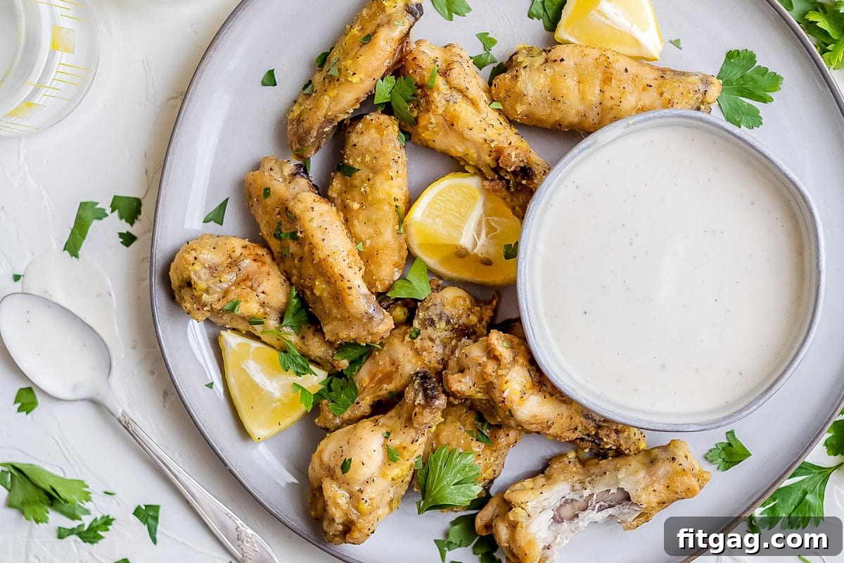 Irresistible Lemon Pepper Wings Baked or Air Fried 10 baked wings on plate with dipping sauce