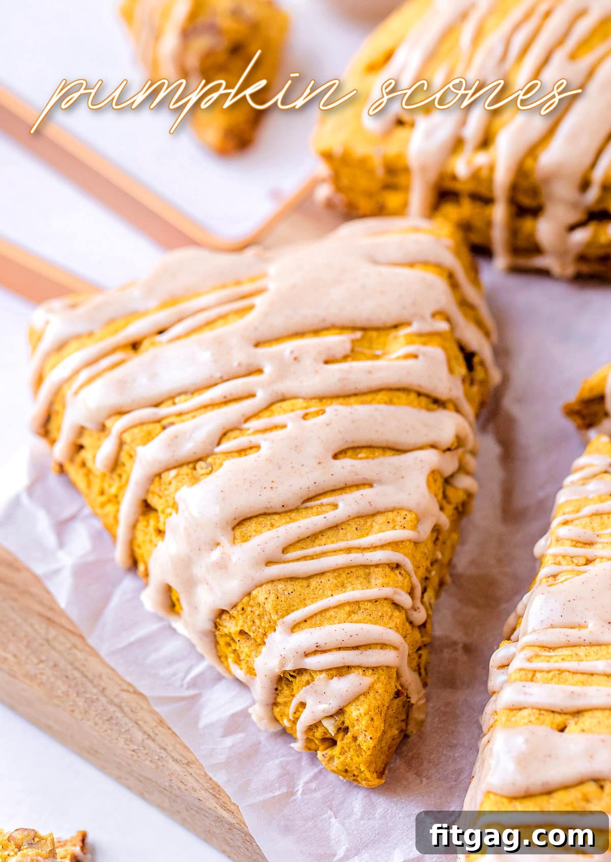 Pumpkin scones with a maple pumpkin pie spice drizzle on top, showcasing a golden-brown texture and appealing glaze.