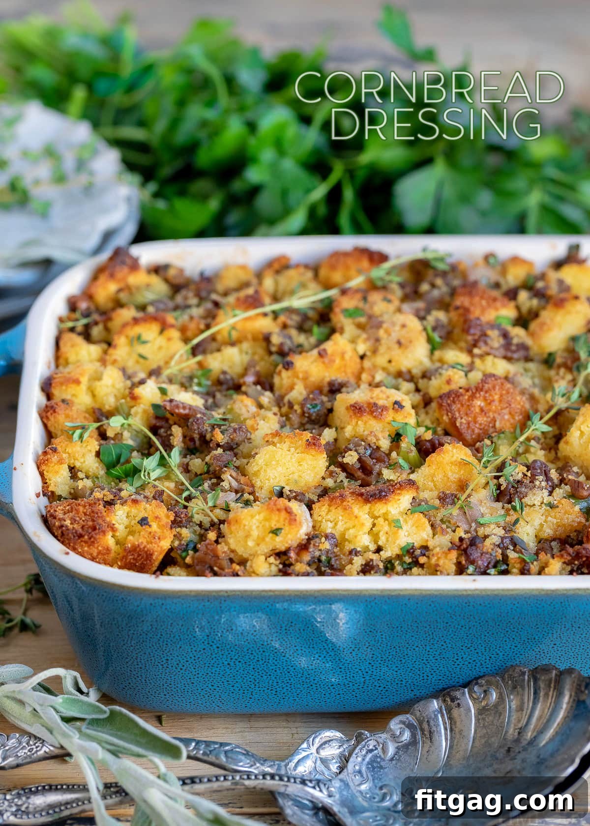 Ultimate Cornbread Dressing 2 Golden cornbread dressing in a casserole dish, garnished with fresh herbs, ready for a Thanksgiving feast. This buttery, savory cornbread stuffing recipe features onions, celery, and optional sausage, promising a moist and crunchy texture for your holiday table.