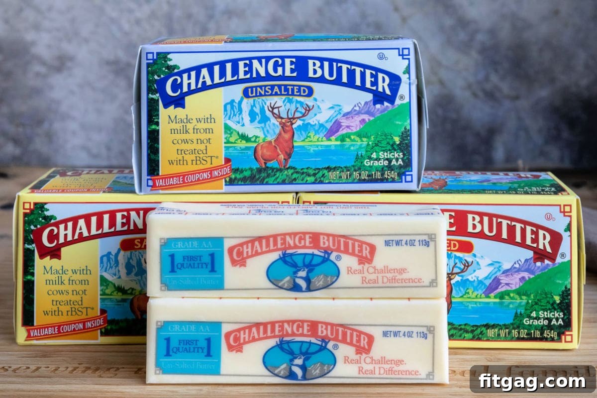 Ultimate Cornbread Dressing 7 Fresh Challenge Butter sticks displayed on a rustic wooden cutting board, ready for use in a delicious recipe. The butter's natural color and texture emphasize its quality as a key ingredient for rich, savory dishes like cornbread dressing.