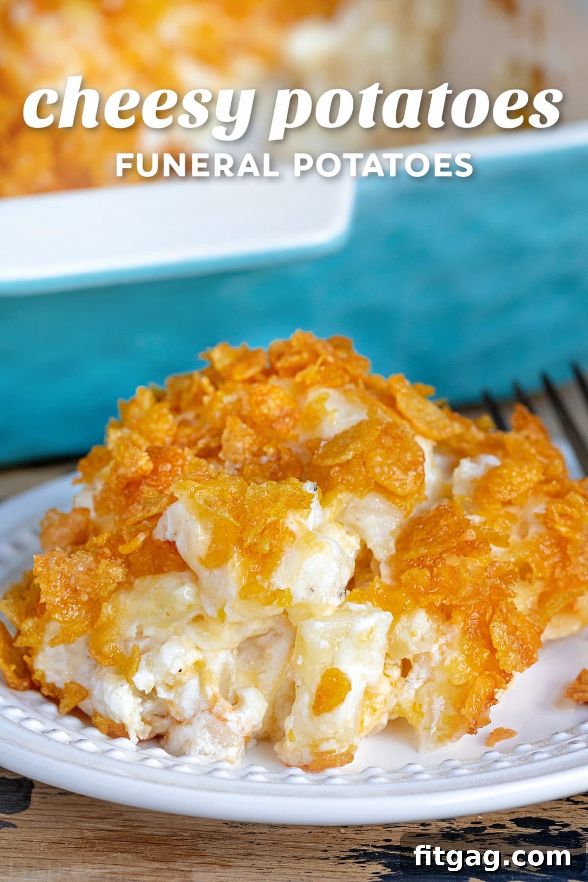 A serving of golden-brown cheesy potatoes on a white plate, with a large casserole dish of the same in the soft-focus background, inviting viewers to indulge in this classic comfort food.