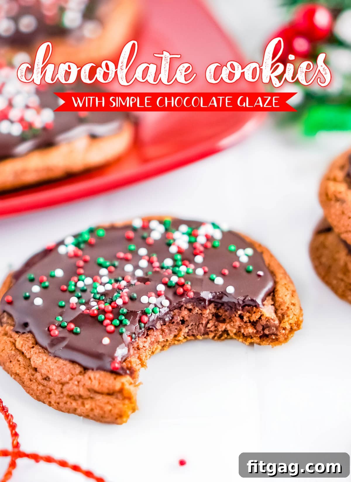 Rich chocolate cookie with a shiny chocolate glaze and vibrant Christmas sprinkles on top, promising a festive and delicious treat.