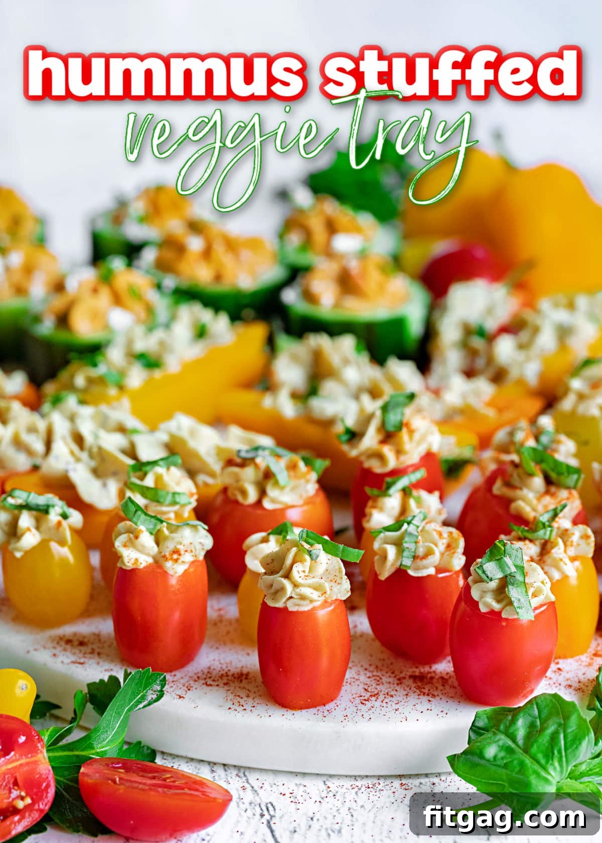 A beautifully arranged hummus stuffed veggie tray on a white marble surface, topped with fresh herbs, ready for serving. The image highlights the vibrant colors of the vegetables and the creamy texture of the hummus.