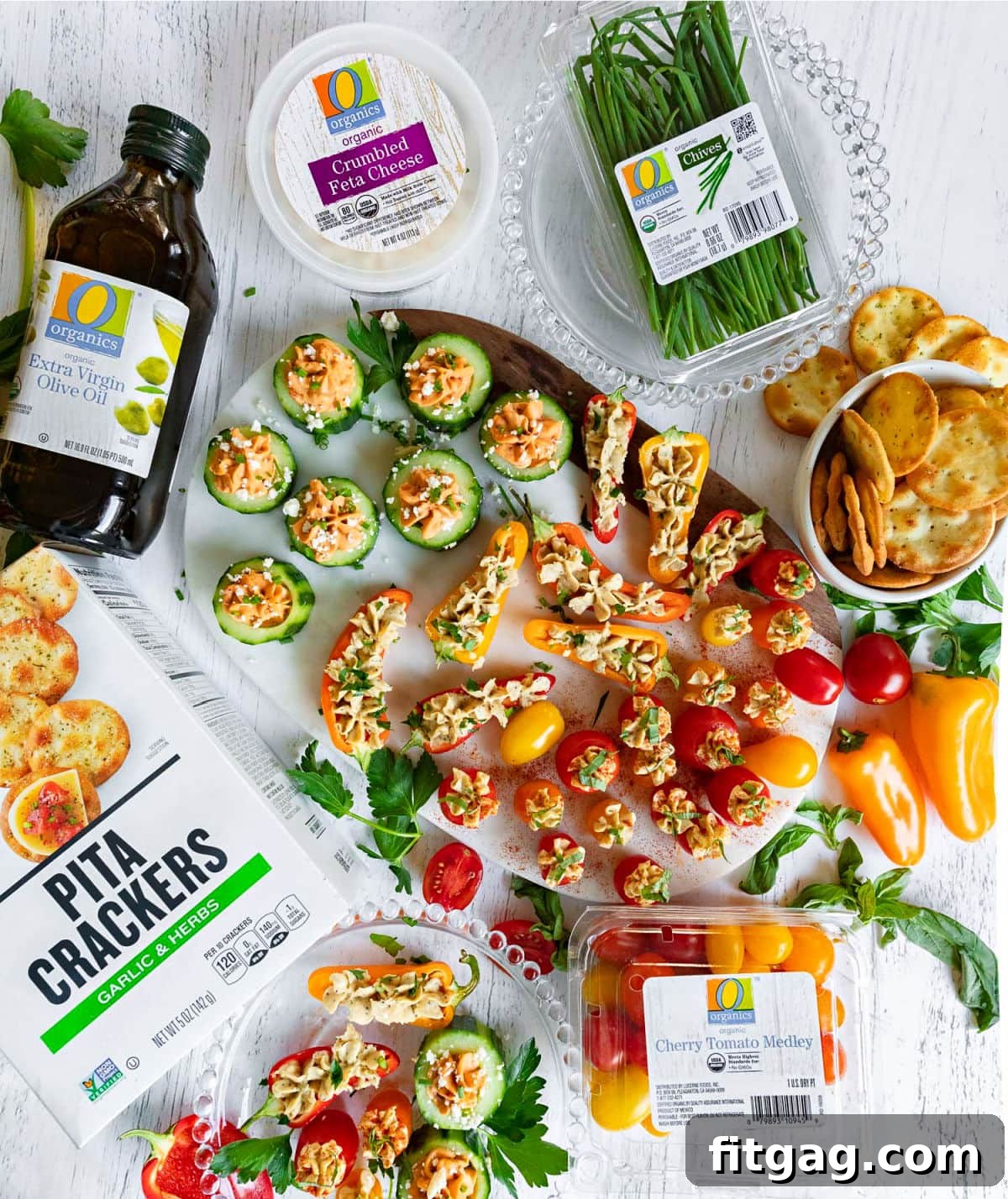 A vibrant flat lay of the complete hummus stuffed veggie tray, surrounded by its individual ingredients, illustrating the freshness and simplicity of the components.