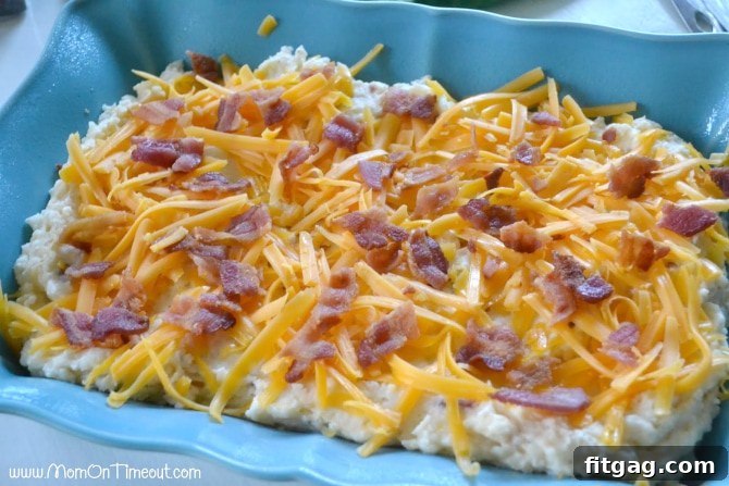 Close-up of baked loaded mashed potatoes, bubbling with cheese and bacon, ready to serve
