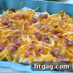 Loaded Mashed Potato Bake in a casserole dish, topped with golden cheese and bacon