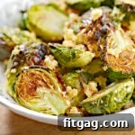 Air fryer Brussels sprouts in a white bowl seasoned with garlic and Parmesan