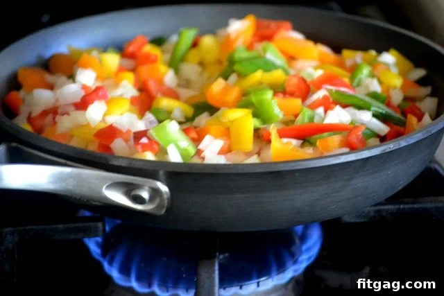 Chopped vegetables and browned meat ready for slow cooker spaghetti sauce