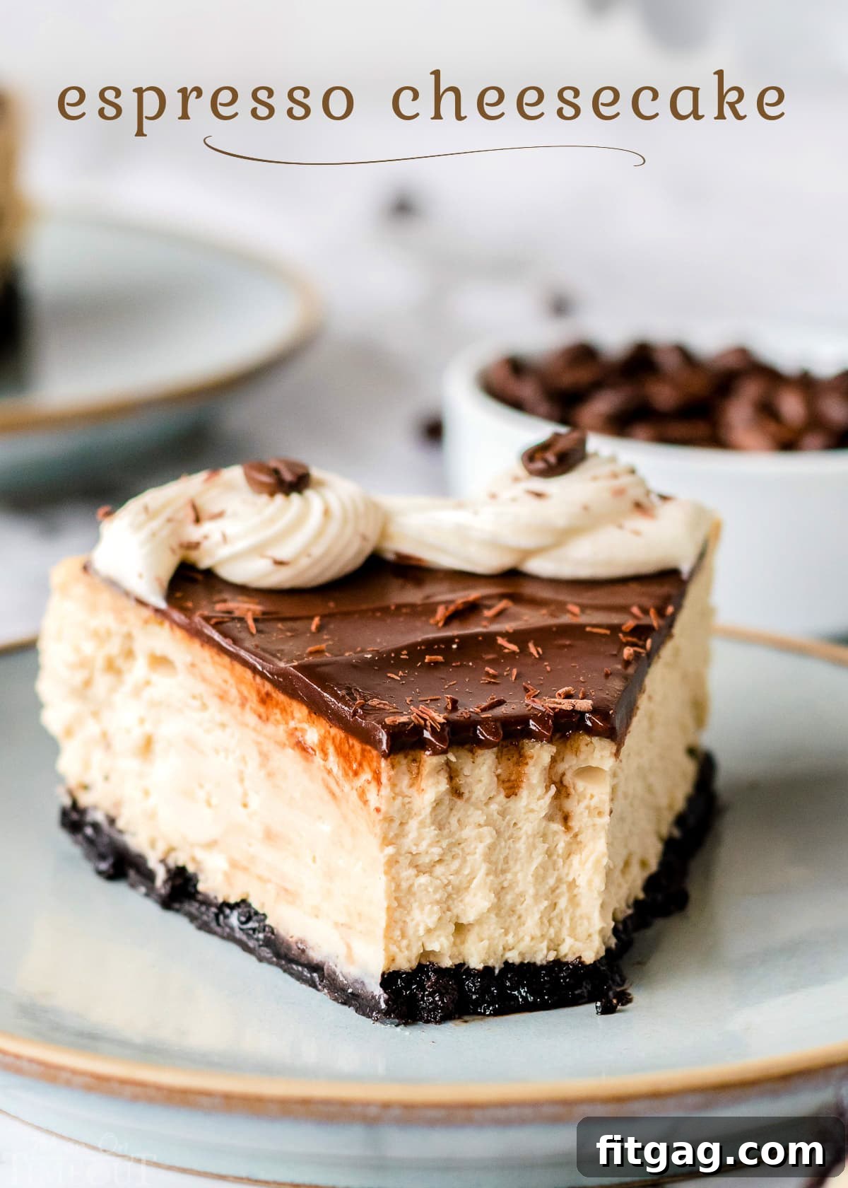 A beautifully plated slice of espresso cheesecake, topped with smooth ganache and a cream cheese frosting swirl, garnished with chocolate shavings and espresso beans. The rich colors of coffee and chocolate are inviting.