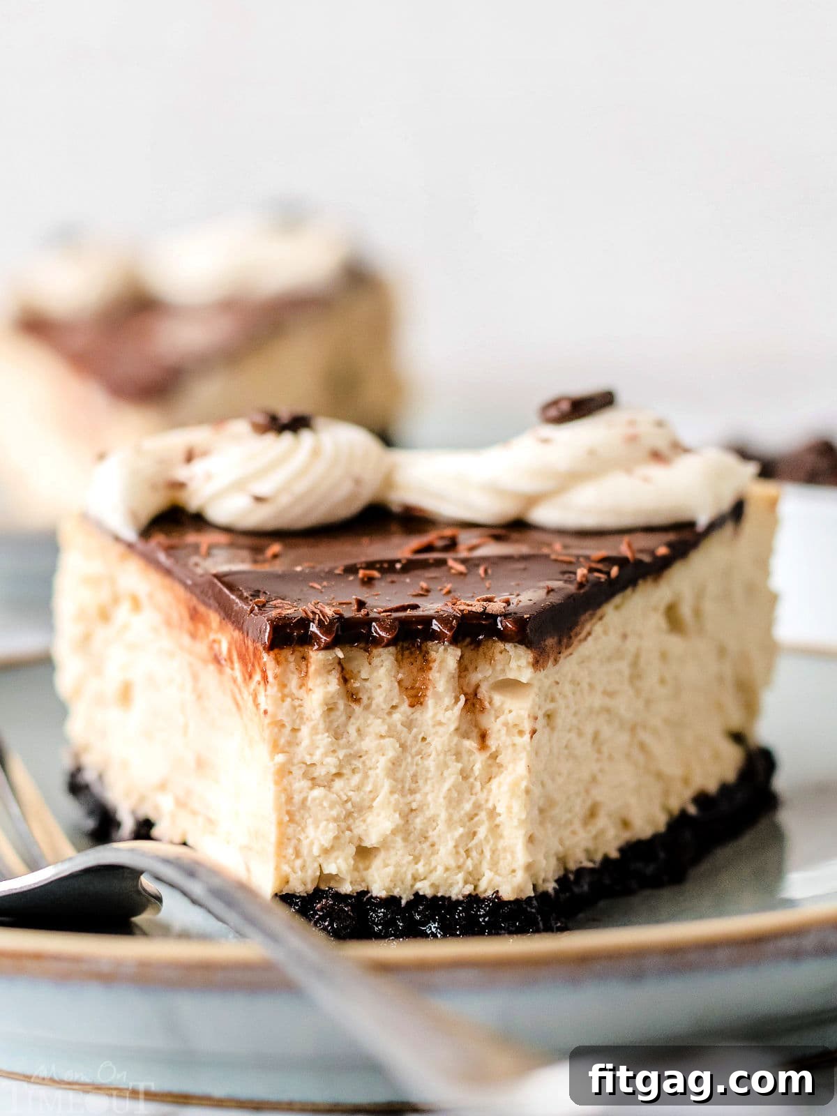 An entire espresso cheesecake on a rustic cake stand, featuring its glossy chocolate ganache topping, elegant cream cheese frosting swirls, and a sprinkle of espresso beans and chocolate shavings.