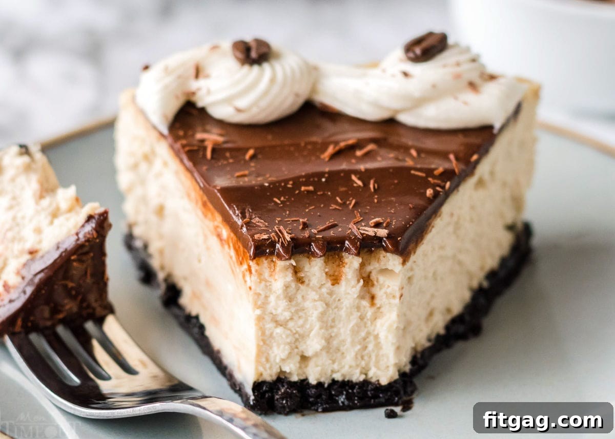 A delectable slice of espresso cheesecake, with a bite taken out, resting on a pale green plate. The rich espresso color of the cake and the dark ganache are clearly visible.