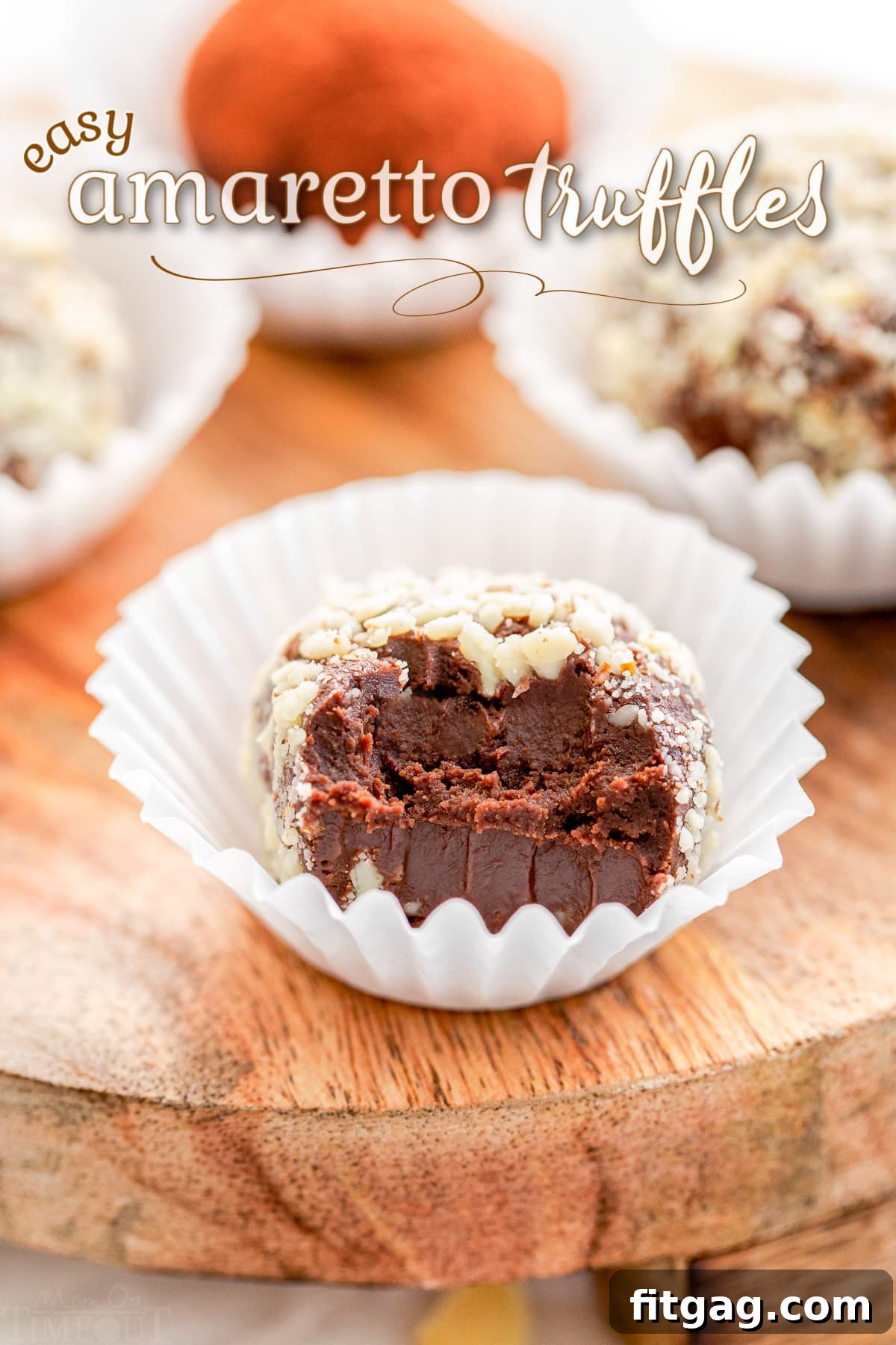 A perfectly crafted Amaretto chocolate truffle, featuring a small bite taken to reveal its rich, dark interior. It rests in a white paper liner on a rustic wooden board, framed by a soft, inviting light and an elegant title overlay.