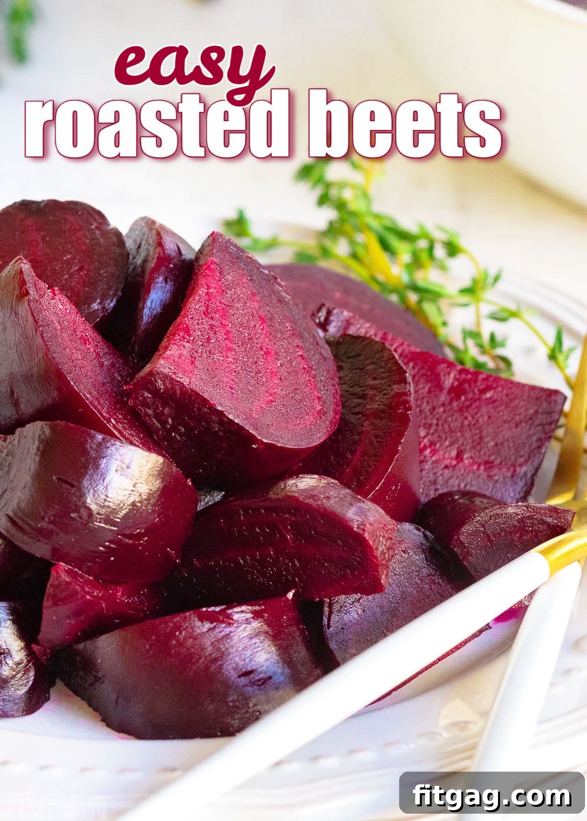 Effortlessly Delicious Roasted Beets 2 roasted beets cut into wedges on white plate with thyme sprig on plate.