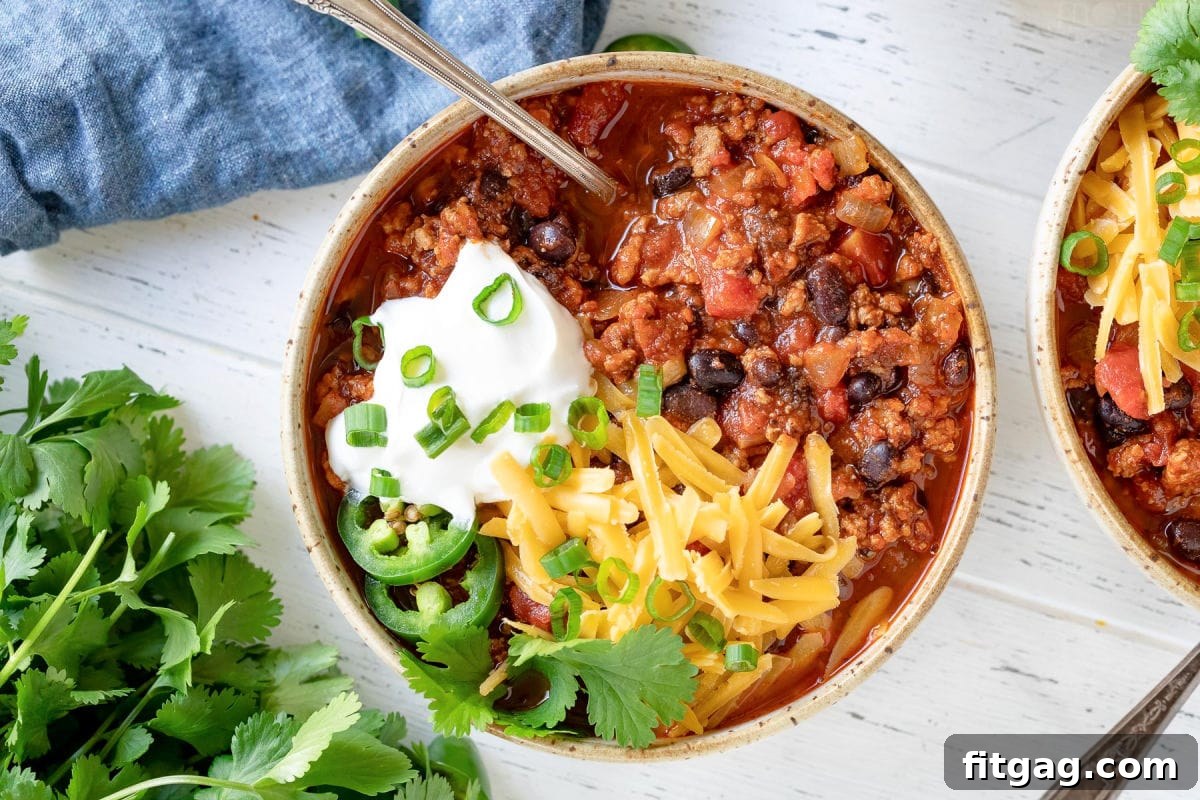 bowl of turkey chili with lots of toppings.