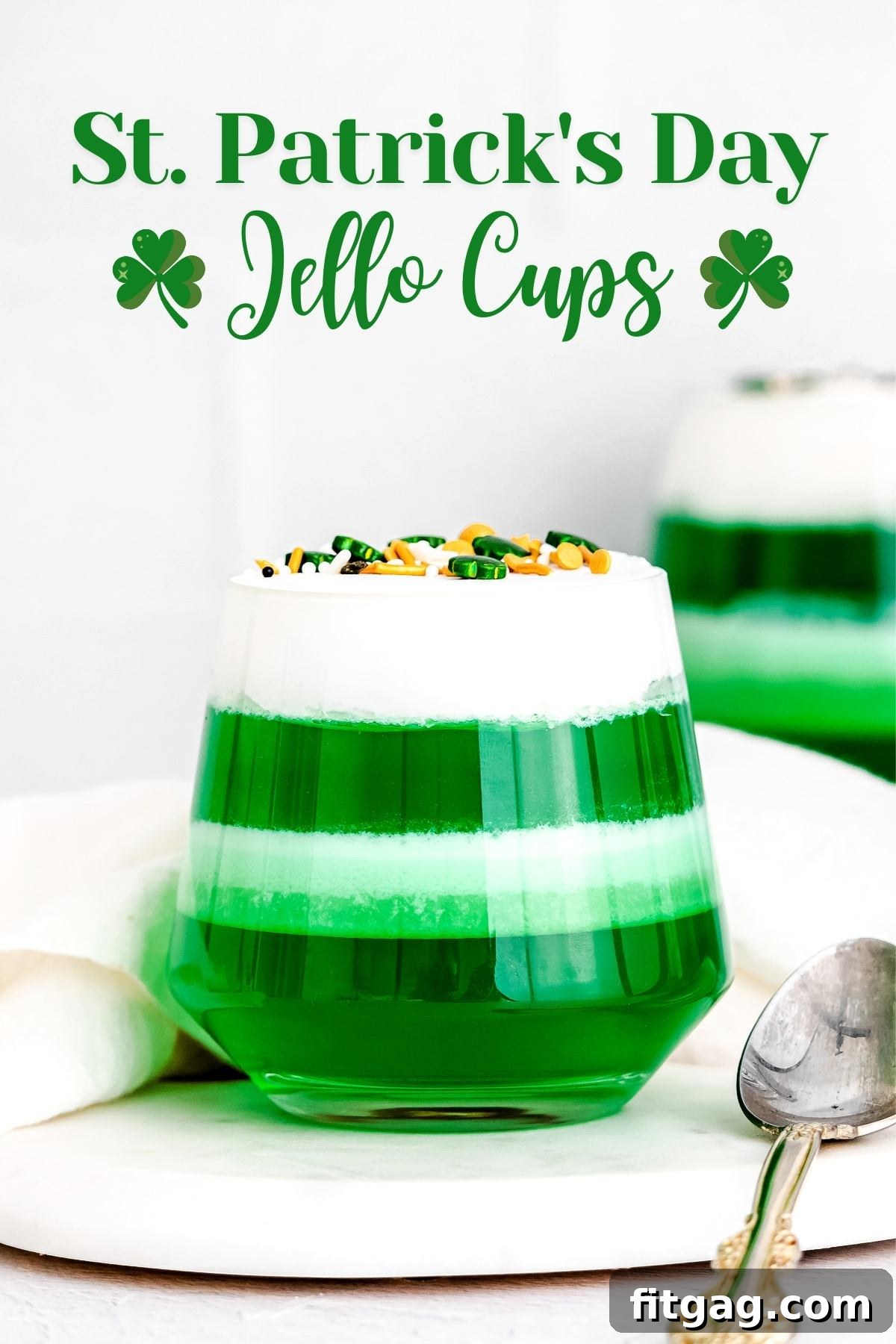 Layered jello cups with green jello and cool whip, showcasing the festive St. Patrick's Day dessert.