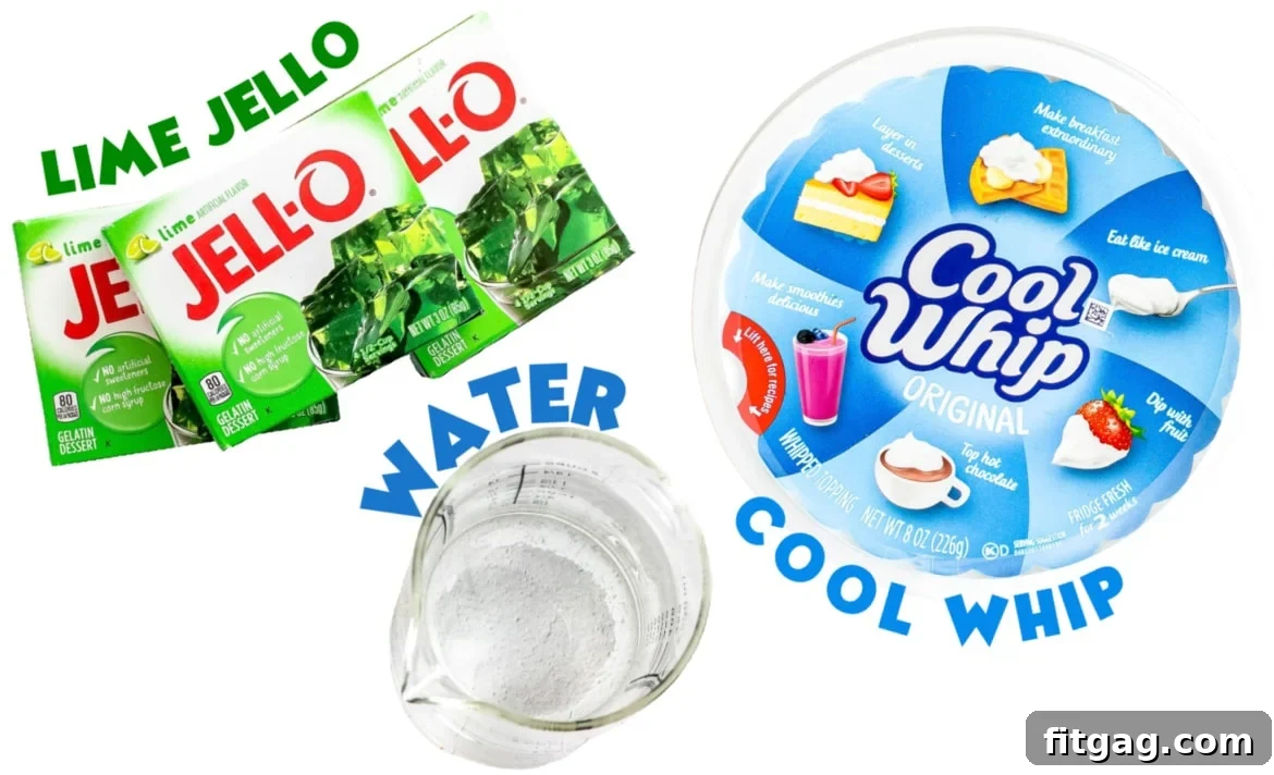 All three simple ingredients for layered jello cups: green jello packets, a tub of Cool Whip, and water, neatly laid out.