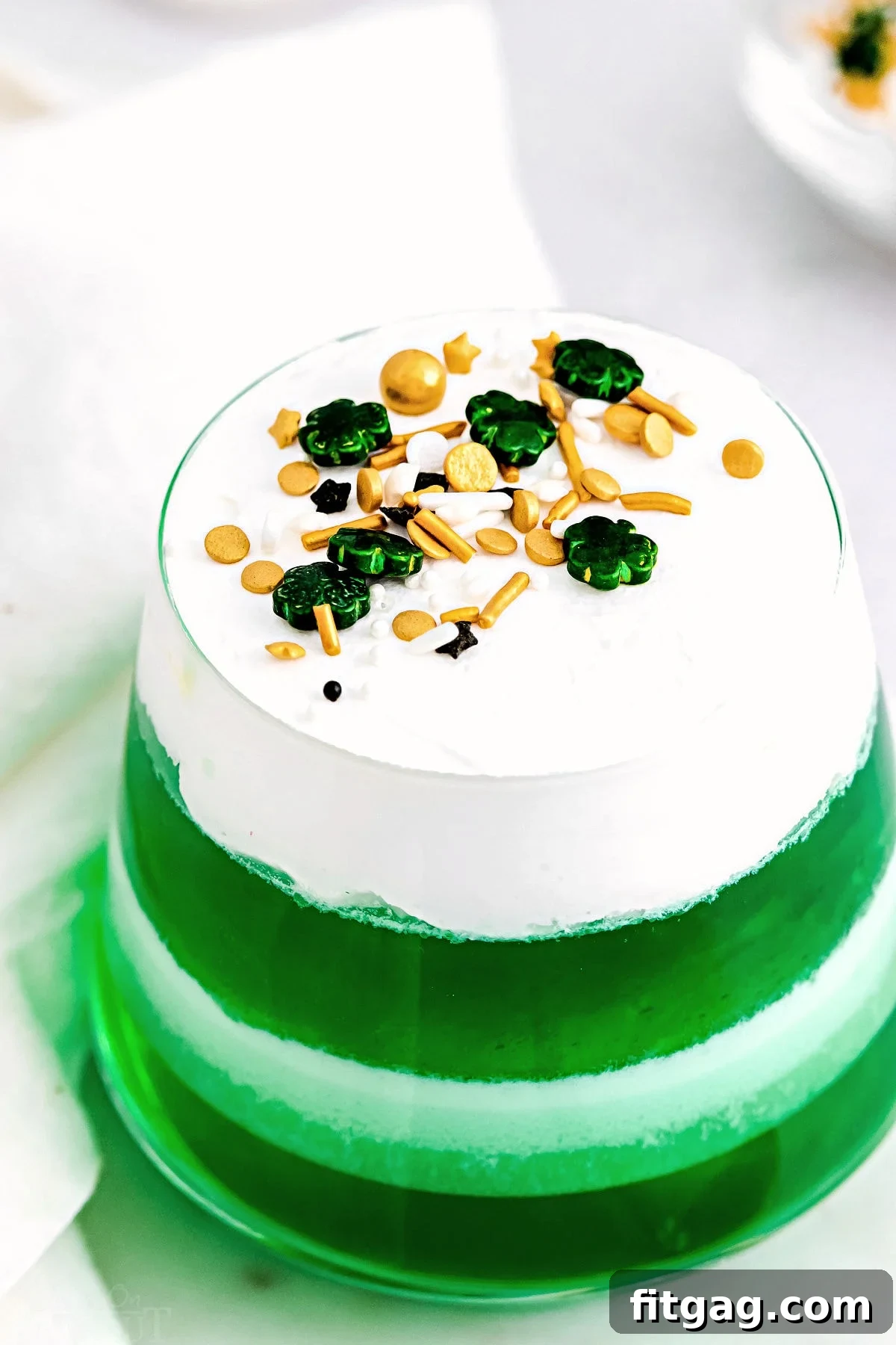 A top-down view of vibrant lime jello layered cups, perfectly set and ready to be enjoyed.