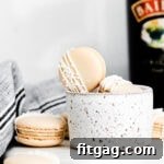 irish cream macarons next to bottle of baileys.