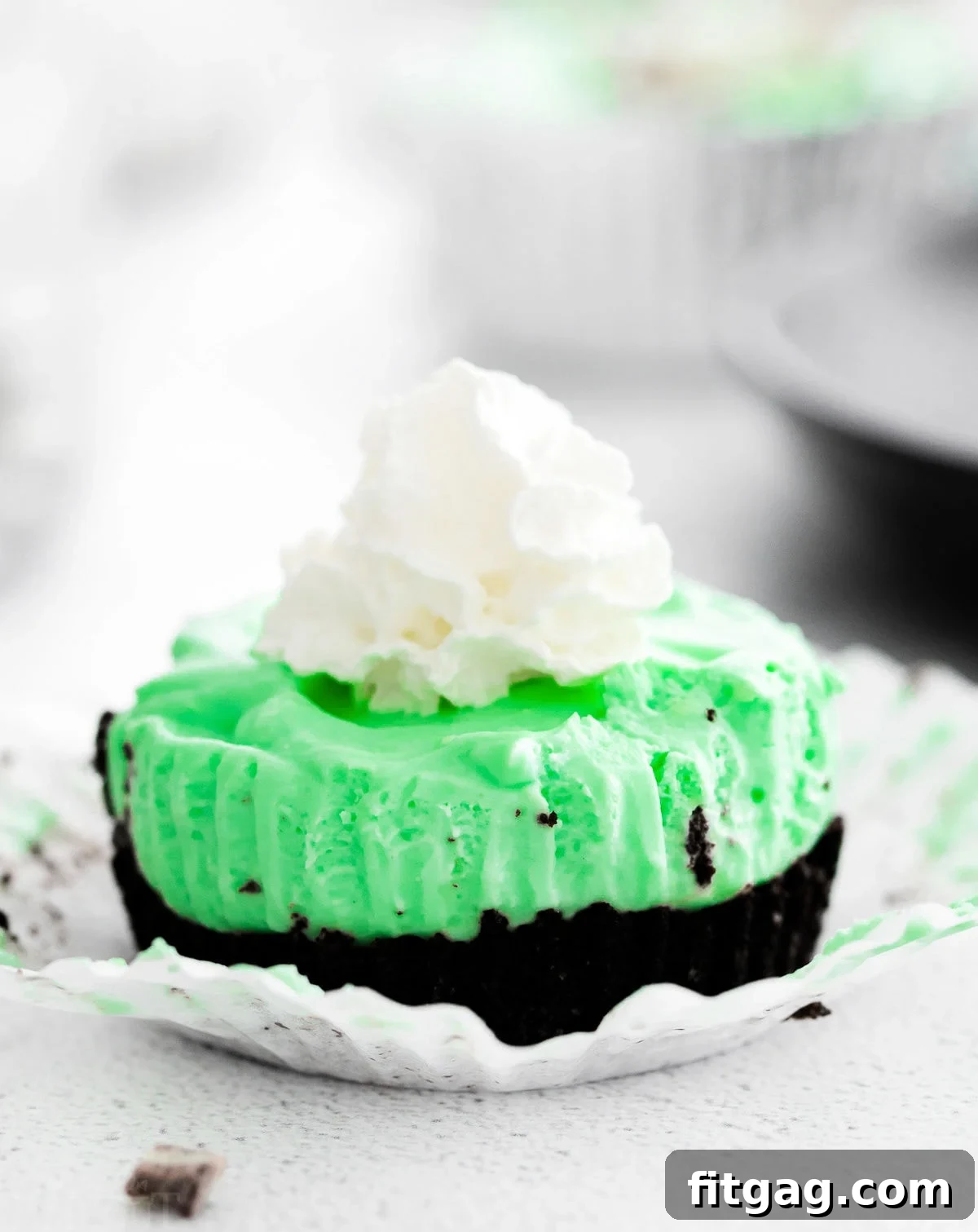 mini cheesecake flavored with creme de menthe liqueur with an oreo crust and topped with whipped cream.